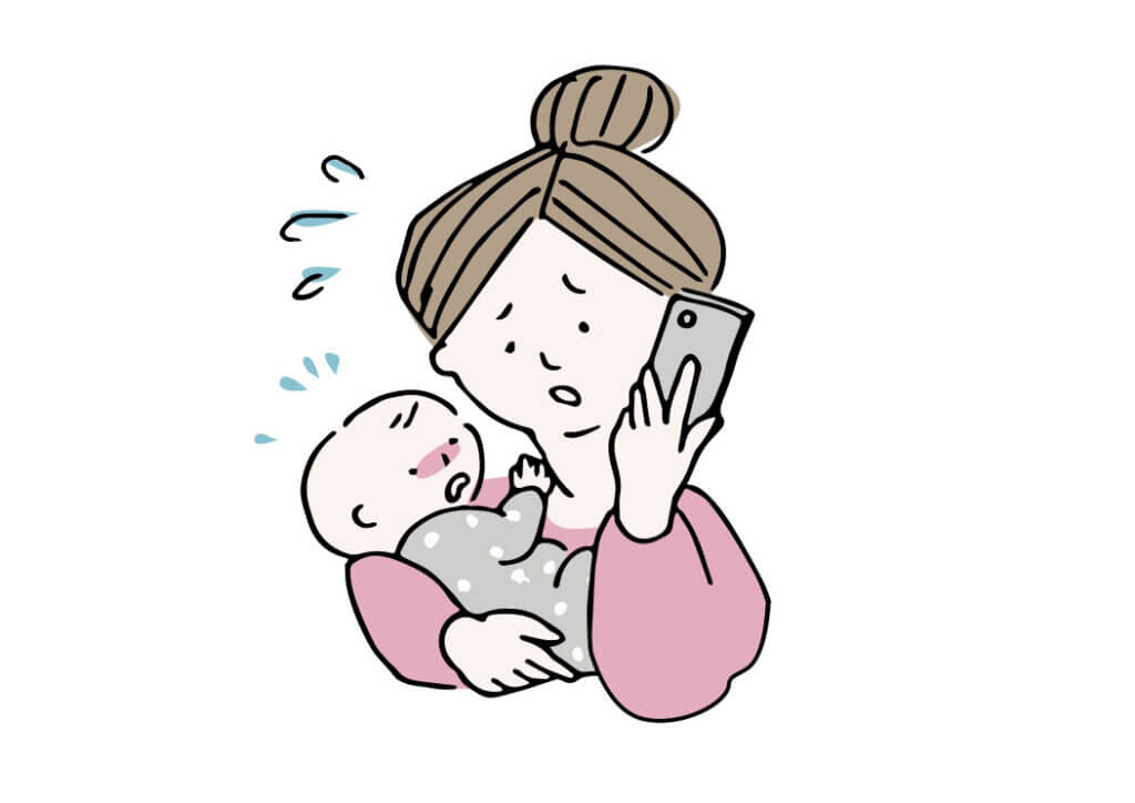 困った様子で電話をする赤ちゃんを抱いた女性