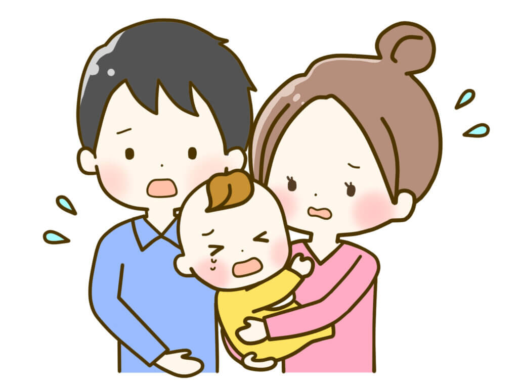 泣いている赤ちゃんを抱く若い両親